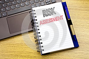 Writing text showing Risk Assessment. Business concept for Safety Danger Analyze written on notebook book on the wooden background