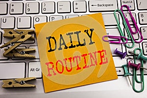 Writing text showing Daily Routine. Business concept for Habitual Lifestyle written on sticky note paper on the white keyboard bac