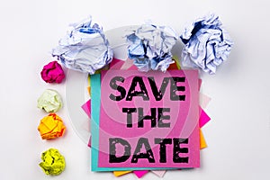 Writing text showing Save The Date written on sticky note in office with paper balls. Business concept for Special Day and G