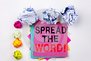 Writing text showing Spread The Word written on sticky note in office with paper balls. Business concept for Announcement Bu