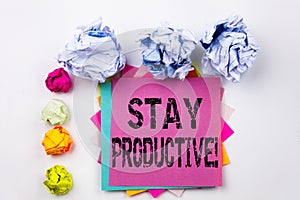 Writing text showing Stay Productive written on sticky note in office with paper balls. Business concept for Concentration E