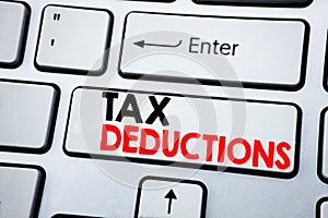 Writing text showing Tax Deductions. Business concept for Finance Incoming Tax Money Deduction written on white keyboard key with