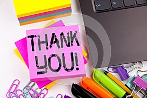 Writing text showing Thank You made in the office with surroundings such as laptop, marker, pen. Business concept for Giving Grati