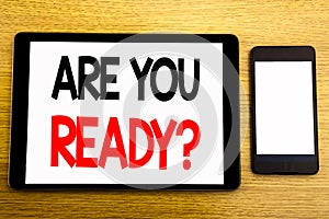 Writing text showing Are You Ready. Business concept for Future Preparation Plan Written on tablet laptop, wooden background with