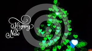 Writing white Happy New Year animation calligraphy lettering text on dark with green bokhe background. Christmas 3D For