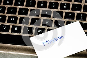 Writing on white label Mission. Text with Mission on a label on keyboard