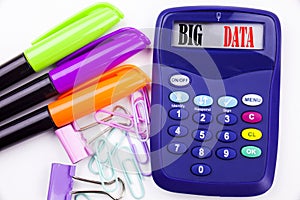 Writing word Big Data text in the office with surroundings such as marker, pen writing on calculator. Business concept for Storage