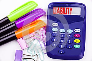 Writing word Liability text in the office with surroundings such as marker, pen writing on calculator. Business concept for Accoun