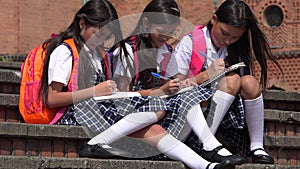 Writing Young Colombian Female Students Wearing School Uniforms
