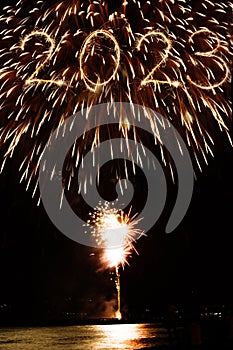 2023 new year coming written with sparkler and fireworks illuminationas a background