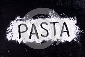 On written flour pasta. Dark background.