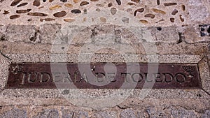 Written (jewish quarter of toledo) on metal plate on the street in Jewish quarter of Toledo