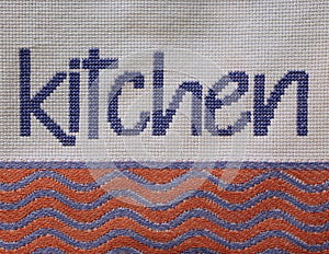 written KITCHEN sewn onto the fabric