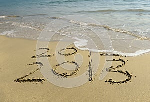2012 and 2013 written in sand