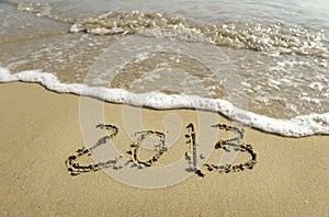 2012 and 2013 written in sand