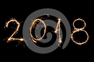 2018 written with Sparkle firework on black background, happy ne