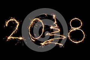 2018 written with Sparkle firework on black background, happy ne
