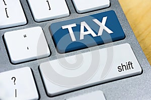 Written word TAX on blue keyboard button