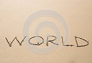 Written word world on sand of beach