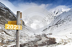 2023 written on yellow postsign  on mountain