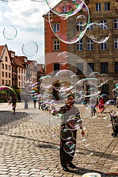 Man launches soap bubbles entertain tourists in the old city cen