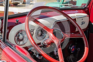 WROCLAW, POLAND - August 11, 2019:  USA cars show: 1951 Renovated Ford F-100 Pickup Truck of red and white colors. Close-up of