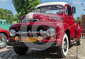 WROCLAW, POLAND - August 11, 2019:  USA cars show: 1951 Renovated Ford F-100 Pickup Truck of red and white colors.r