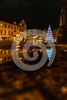 Wroclaw market square at night with some of walking people, glowing lanterns and beautifully and