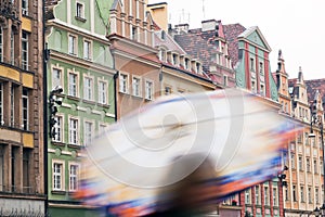 Wroclaw, Poland. A person with umbrella on the rainy market square