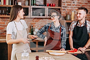 Wrong recipe. Young woman with tablet pc feeling awkward to frie