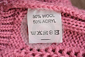 Wrong side of a pink knitted sweater made of wool