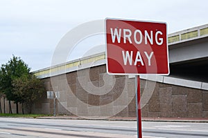 Wrong Way sign by a highway.