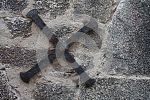 wrought iron cross bracing supporting the stone facade of an old medieval house