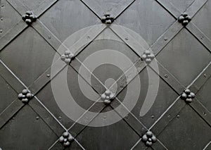 Wrought iron door with grid pattern. medieval style with rivets