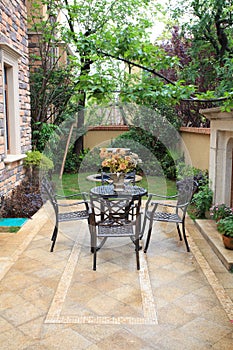 Wrought iron furniture in airy courtyard photo