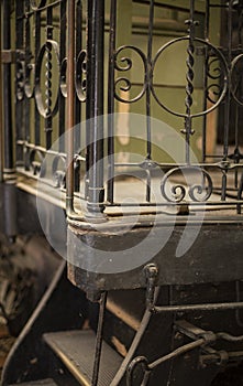 Wrought iron gate and rails around a steam engine