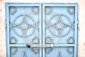 wrought-iron gates in a stone fence  covered with snow