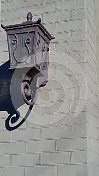 Wrought iron lantern on brick wall. Copyspace
