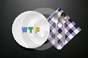 WTF slogan letters on plate with fork and knife