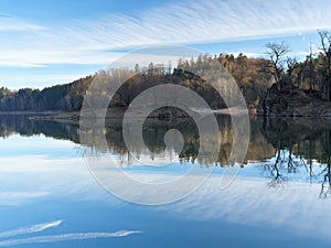 The Wuppertalsperre reservoir with a dam on the Wupper River. In the center of the frame, a small island in the middle of the lake