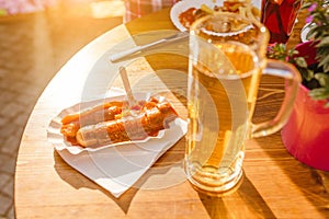 Wurst Sausages with beer on the table in outdoor restaurant