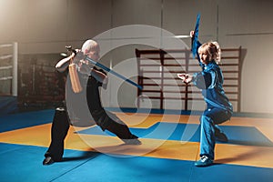Wushu fighters, man and woman with swords