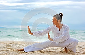Wushu man on the beach photo