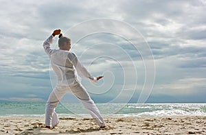 Wushu man on the beach