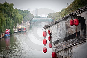 Wuxi old town, Jiangsu Province. Chinese lanterns hang from an ancient building along the Grand Canal - China