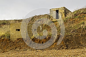 WW2 sea defences slipping down the cliff side due to coastal erosion on the suffolk coastline. photo