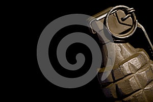 WW2 hand grenade against a black background.