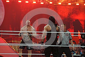 WWE Champion Brock Lesner stares across ring at Roman Reigns as