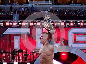 WWE Wrestler John Cena holds up USA Championship title after winning match