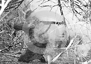 WWII Soldier Firing M1 Rifle Through Smoke